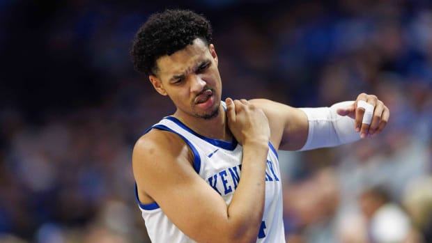 Feb 13, 2024; Lexington, Kentucky, USA; Kentucky Wildcats forward Tre Mitchell (4) returns to the bench holding his shoulder during the second half against the Ole Miss Rebels at Rupp Arena at Central Bank Center. Mandatory Credit: Jordan Prather-USA TODAY Sports